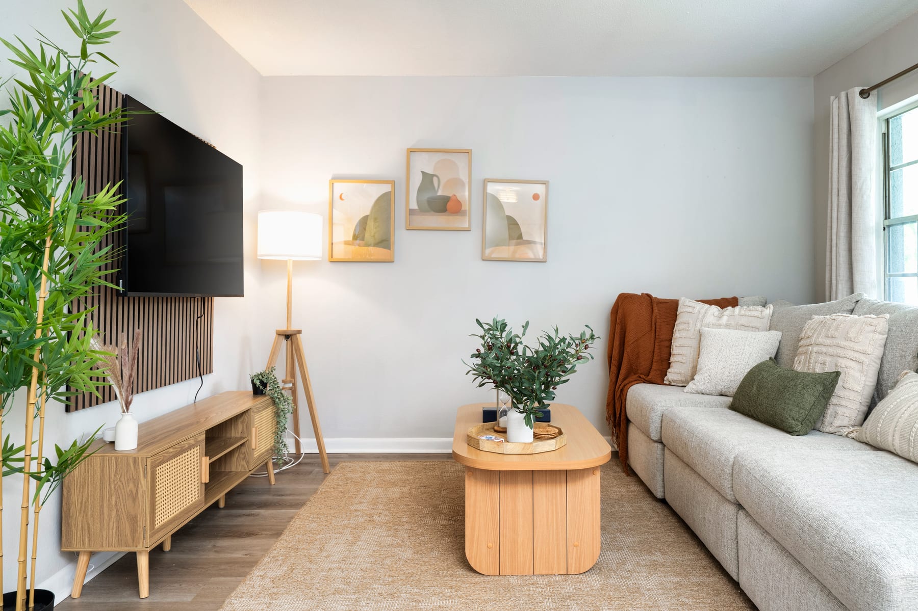 The living room with sofa bed, smart TV, and reading nook